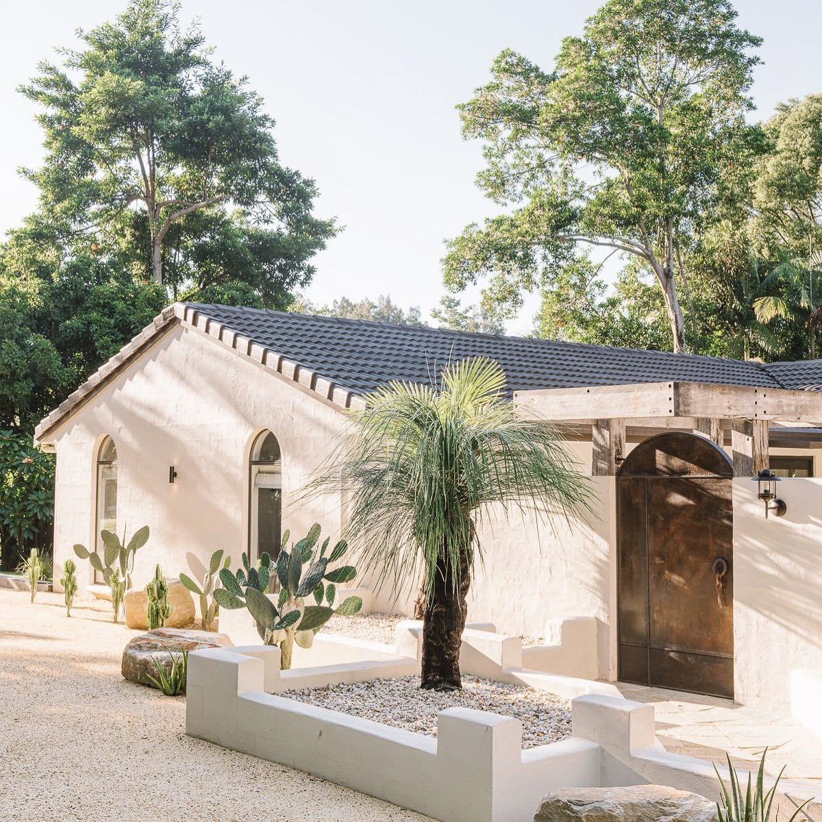 The white Spanish-plastered barn at Two Acres, Clunes, surrounded by rainforest
