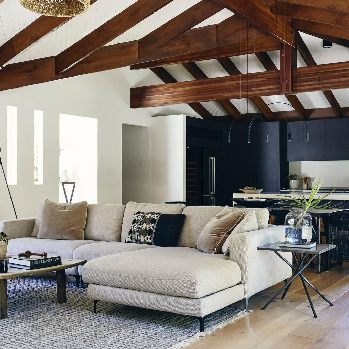 Open-plan living room with timberland ceilings