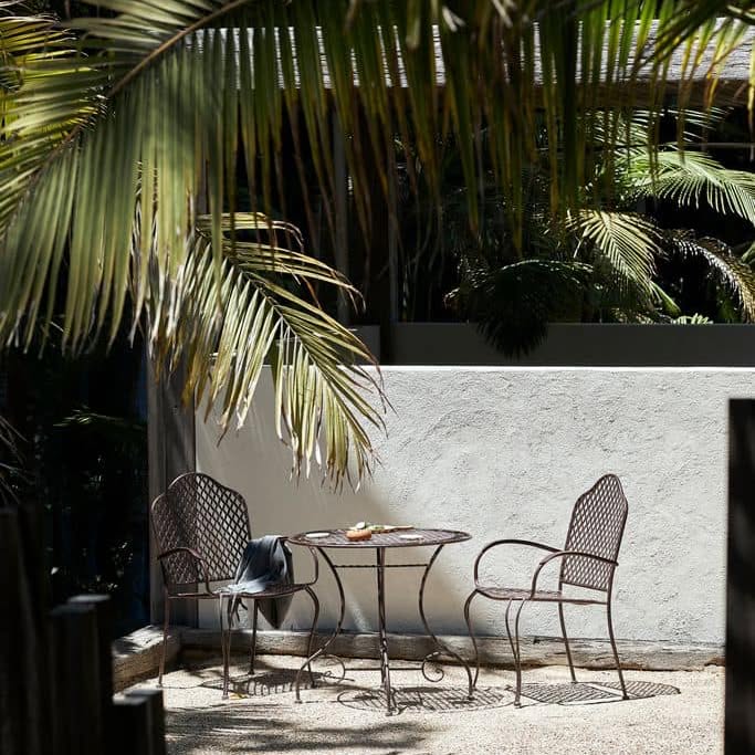 White courtyard with wicker chairs